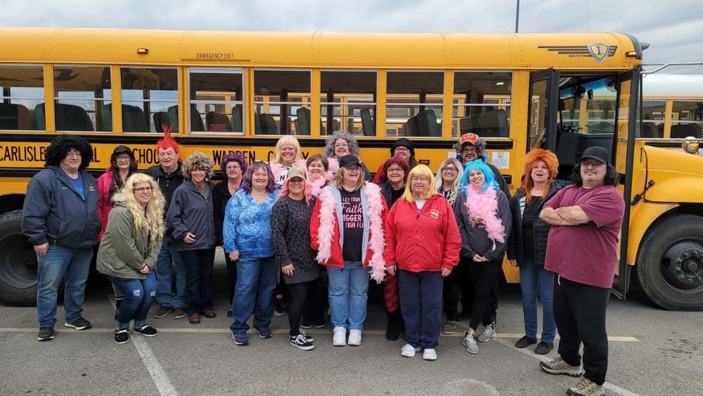 Gail Harvery and friends in front of school bus