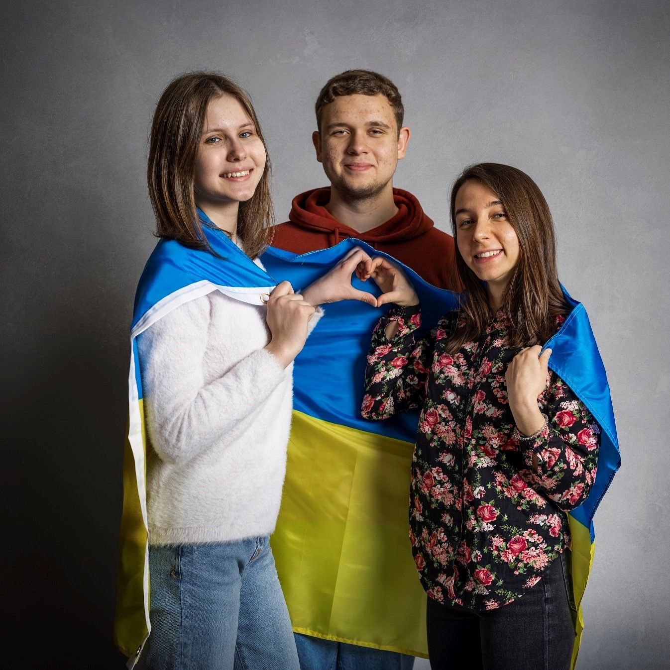 Ukrainian students drape their flag over their shoulders
