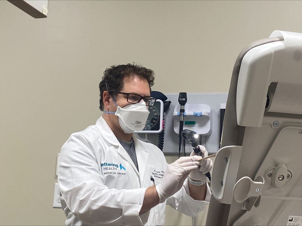 Dr. Jordan Knox looking for strep throat